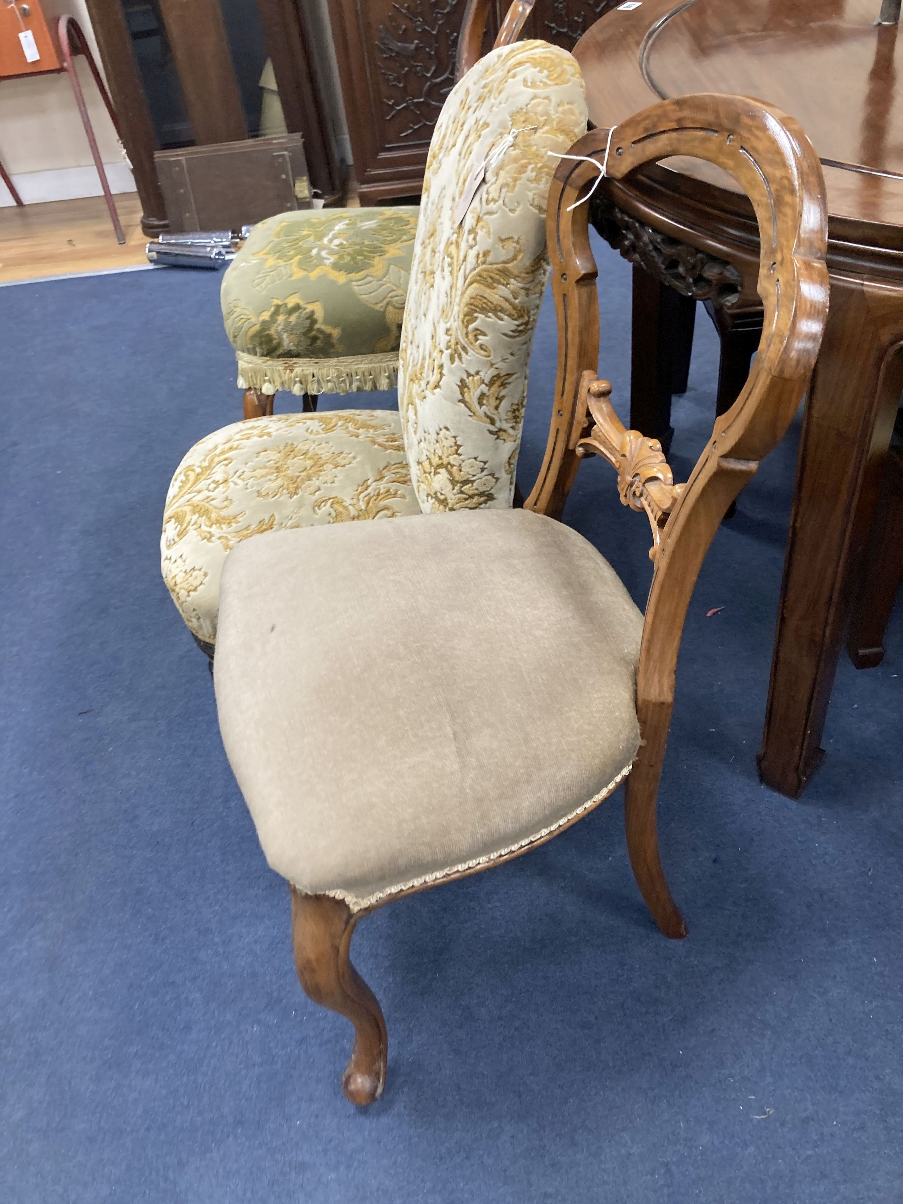 A Victorian ebonised and gilt upholstered nursing chair and pair of balloon back chairs